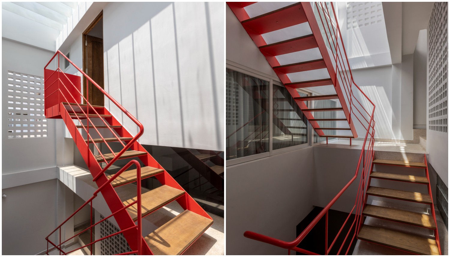 Cầu thang khung kim loại sơn màu đỏ cam ấm áp, như một điểm nhấn kiến trúc cho khu vực thông tầng của nhà phố Sài Gòn.