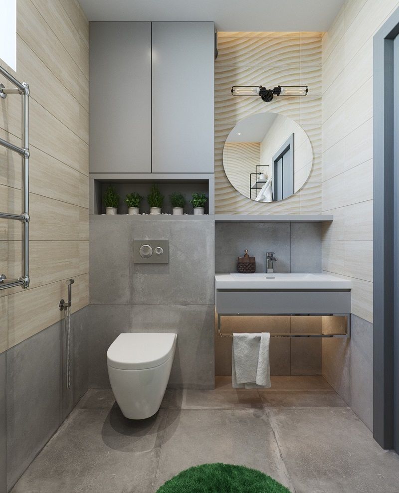 Phòng tắm - vệ sinh tông màu xám bê tông mộc mạc trong nhà ống 2 tầng. Gương tròn tô điểm nét mềm mại tinh tế cho căn phòng.